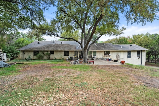 rear view of property with a patio area and a lawn