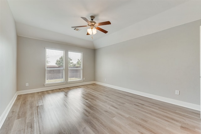 empty room with light wood-type flooring, lofted ceiling, and ceiling fan