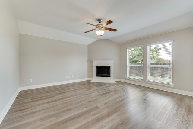 unfurnished living room featuring light hardwood / wood-style flooring, ceiling fan, and vaulted ceiling