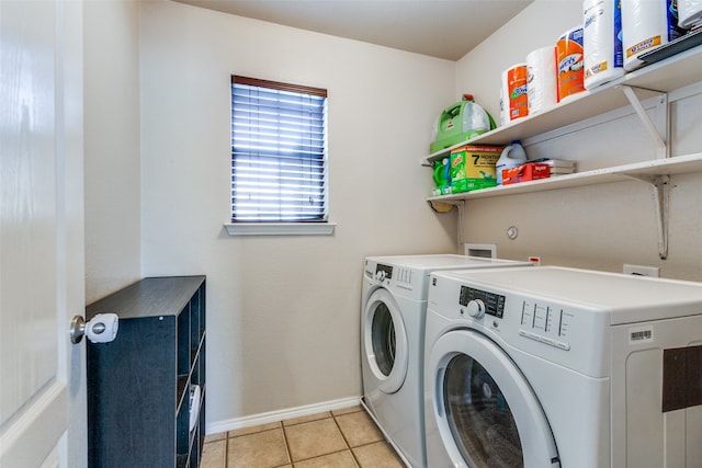 clothes washing area featuring washing machine and clothes dryer and light tile patterned floors