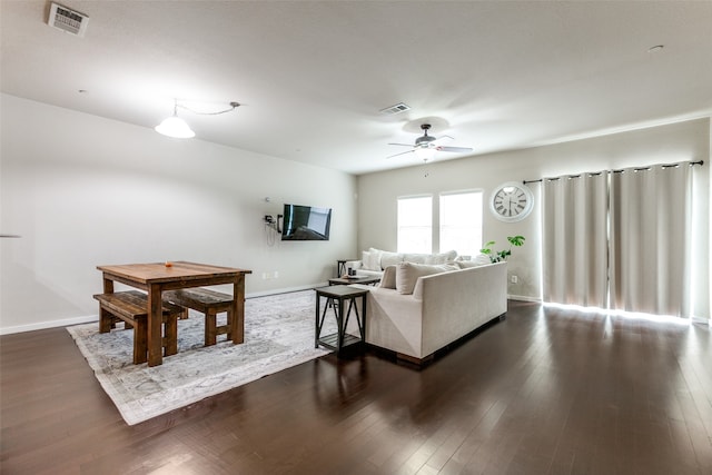 living room with ceiling fan and dark hardwood / wood-style floors