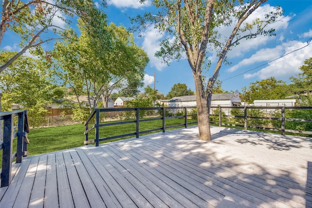 wooden terrace featuring a lawn