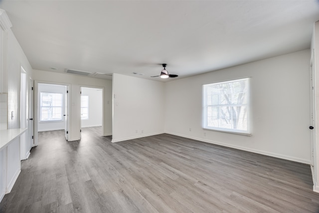 unfurnished living room featuring light wood-type flooring and ceiling fan