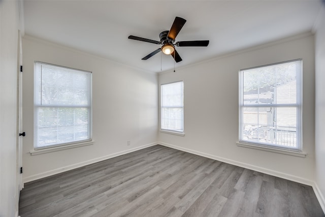 spare room featuring ceiling fan, light hardwood / wood-style floors, and ornamental molding