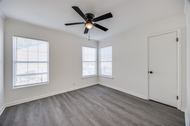 empty room featuring ceiling fan, hardwood / wood-style flooring, and crown molding