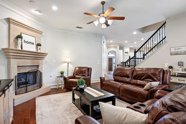 living room featuring ornamental molding, ceiling fan, and dark hardwood / wood-style floors