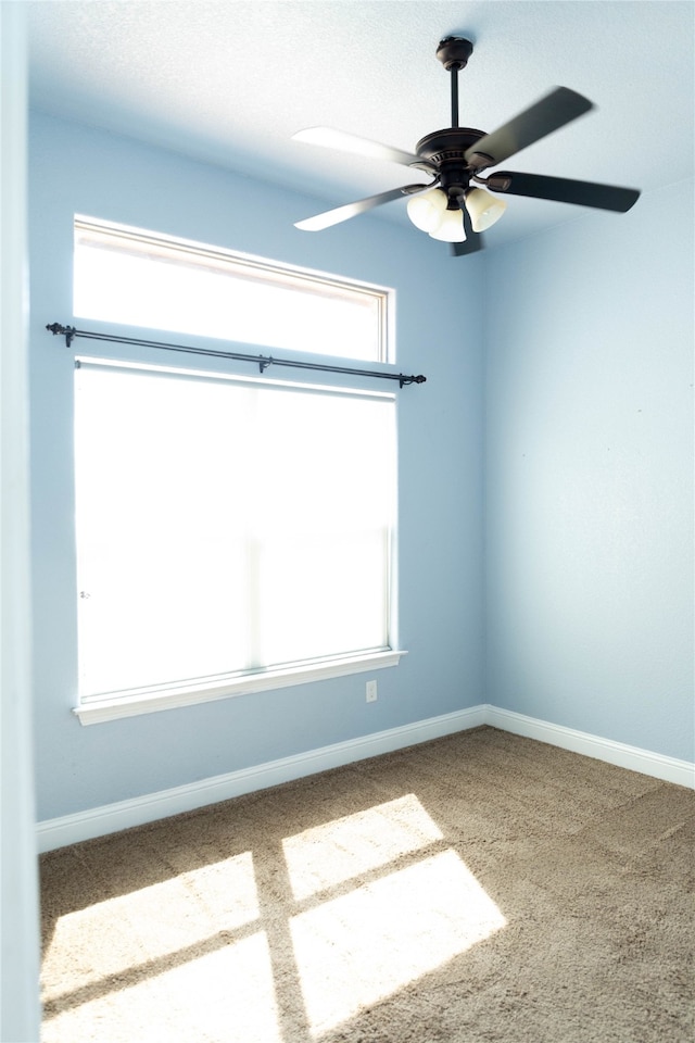 empty room with carpet flooring and ceiling fan