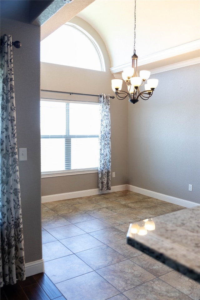 empty room with a notable chandelier and tile patterned floors