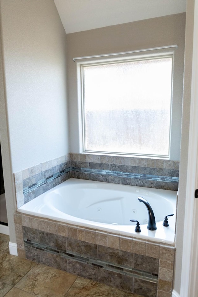 full bath with tile patterned floors and a jetted tub