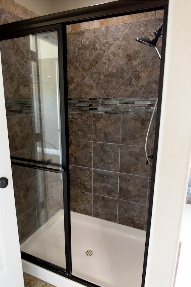 bathroom with a shower with shower door