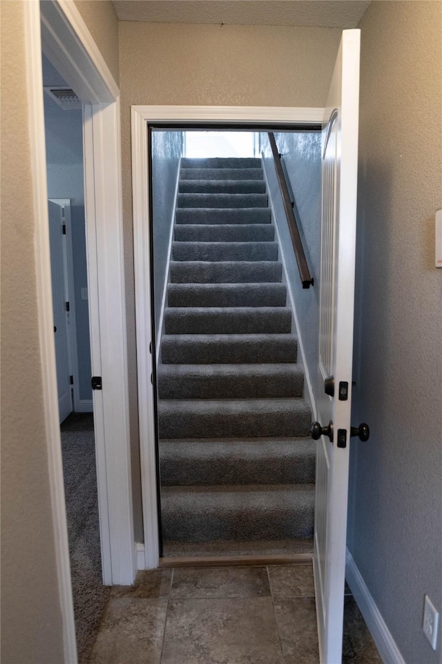 stairs with baseboards and visible vents