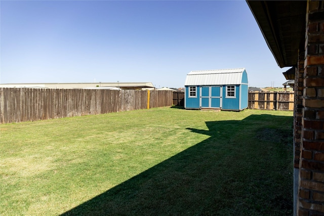 view of yard featuring a fenced backyard, an outdoor structure, and a shed