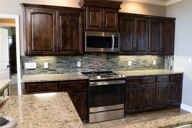 kitchen with appliances with stainless steel finishes, dark brown cabinetry, ornamental molding, and tasteful backsplash