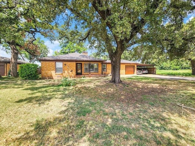 ranch-style house featuring a garage, a front yard, and a carport