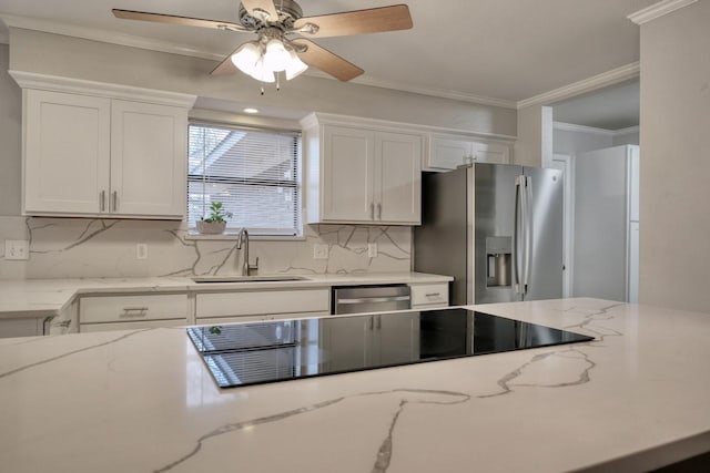 kitchen with white cabinetry, backsplash, stainless steel appliances, decorative light fixtures, and ceiling fan