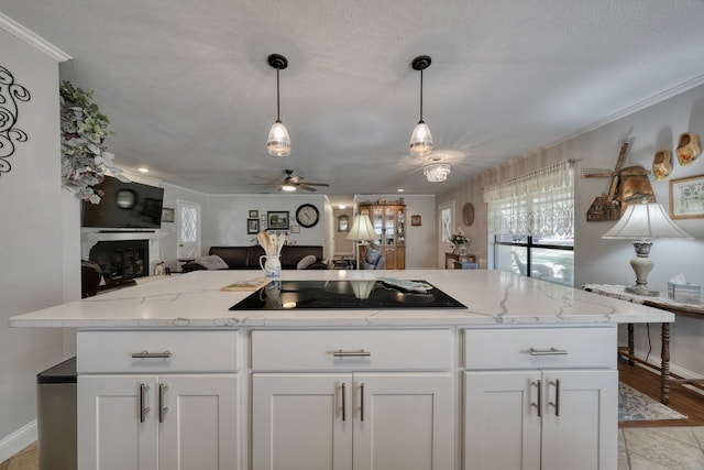 kitchen featuring light wood-type flooring, white cabinets, ceiling fan, and black electric cooktop