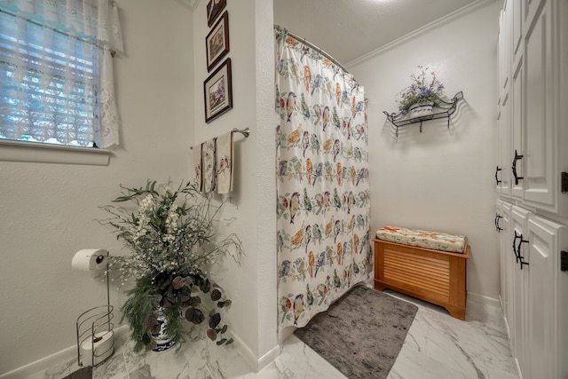 bathroom with curtained shower and ornamental molding