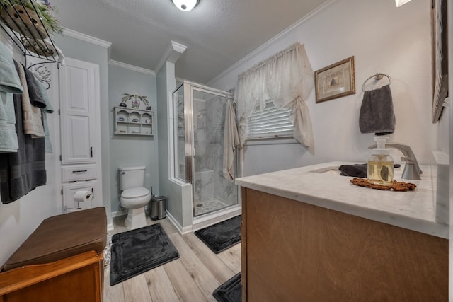 bathroom with toilet, an enclosed shower, vanity, a textured ceiling, and hardwood / wood-style flooring