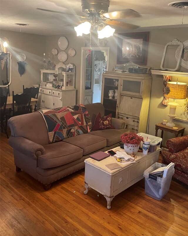 living room with lofted ceiling, wood-type flooring, and ceiling fan