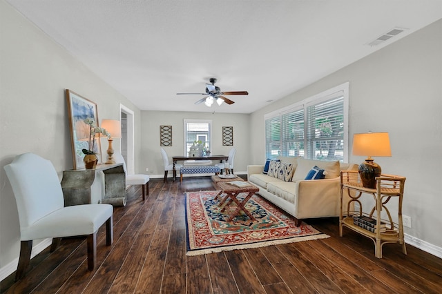 living room with ceiling fan and dark hardwood / wood-style flooring