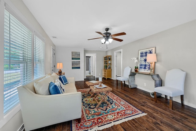 living room with dark wood-type flooring and ceiling fan