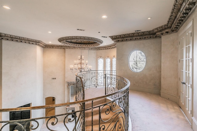 hallway featuring crown molding, light colored carpet, and a chandelier