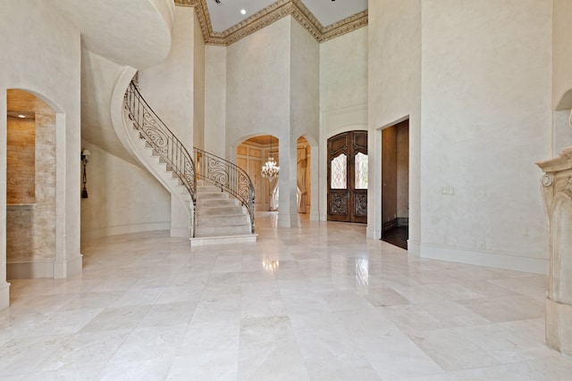 entryway featuring an inviting chandelier and a high ceiling