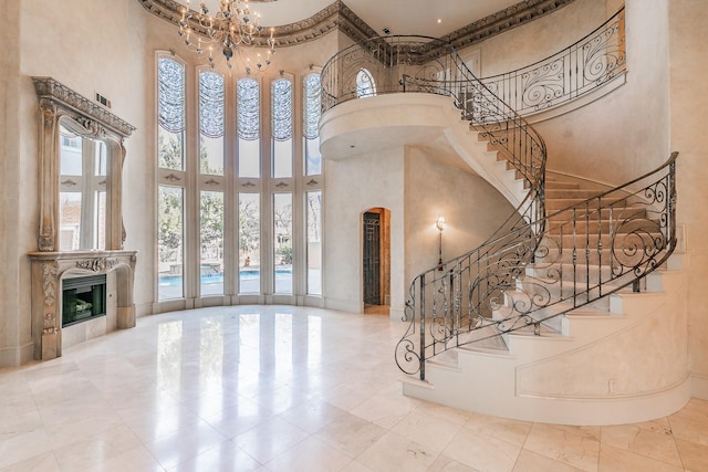 entryway featuring a towering ceiling and a chandelier