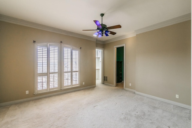 spare room featuring light carpet, ornamental molding, and ceiling fan