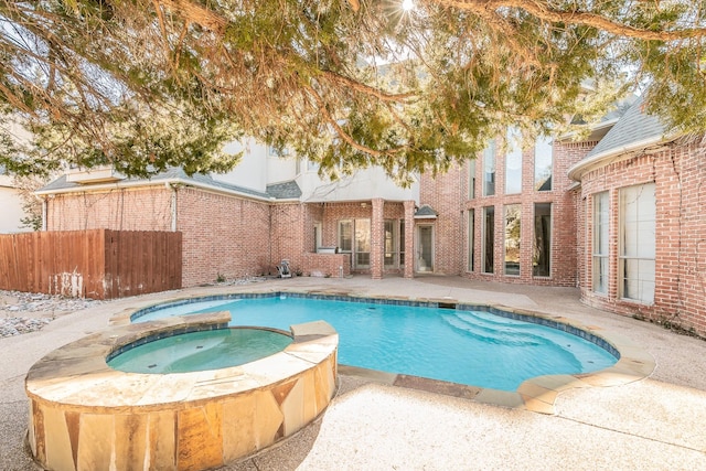 view of pool featuring an in ground hot tub