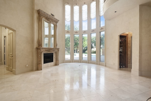 unfurnished living room with a high ceiling