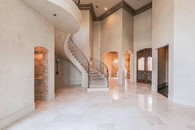 entryway featuring a towering ceiling