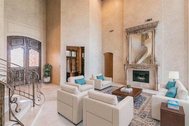 living room featuring light tile patterned floors and a high ceiling