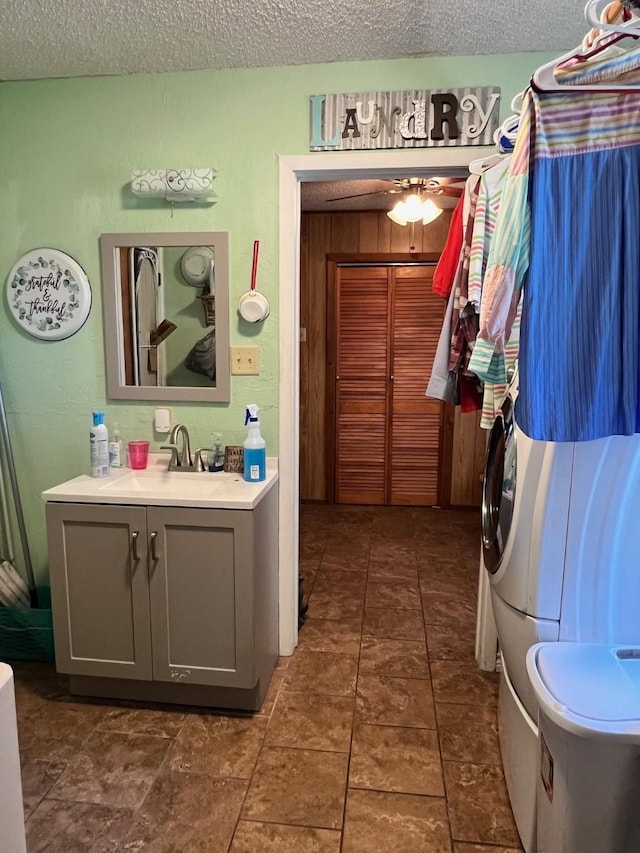 bathroom featuring a textured ceiling, ceiling fan, and vanity