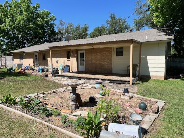 back of property featuring a yard, brick siding, and cooling unit