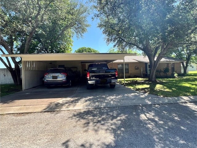 view of car parking with a carport and concrete driveway