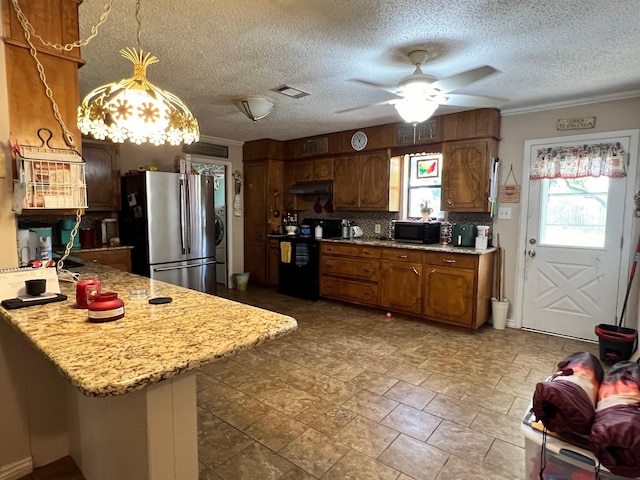 kitchen featuring under cabinet range hood, brown cabinets, a peninsula, black appliances, and a ceiling fan