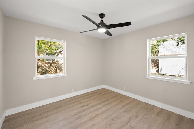 empty room with ceiling fan and light hardwood / wood-style floors