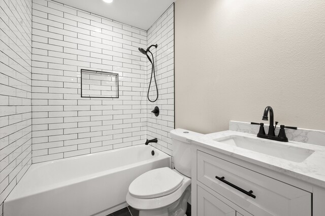 full bathroom with tiled shower / bath combo, vanity, and toilet