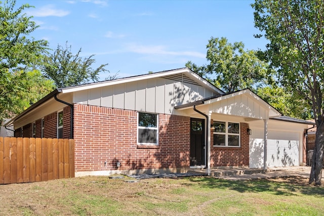 view of front of home featuring a garage and a front lawn