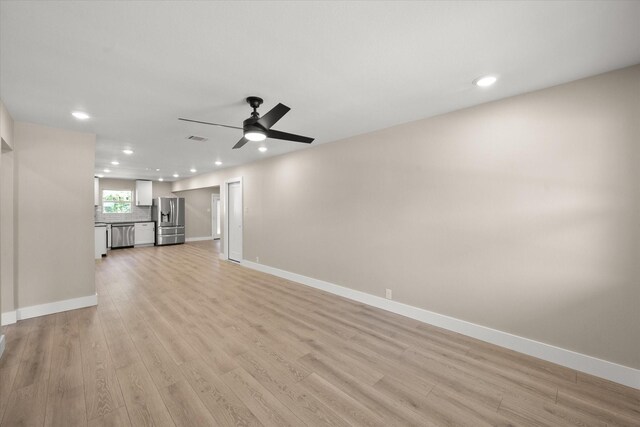 unfurnished living room featuring ceiling fan and light hardwood / wood-style floors