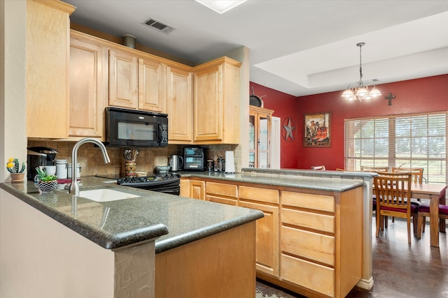 kitchen with kitchen peninsula, a chandelier, and light brown cabinetry