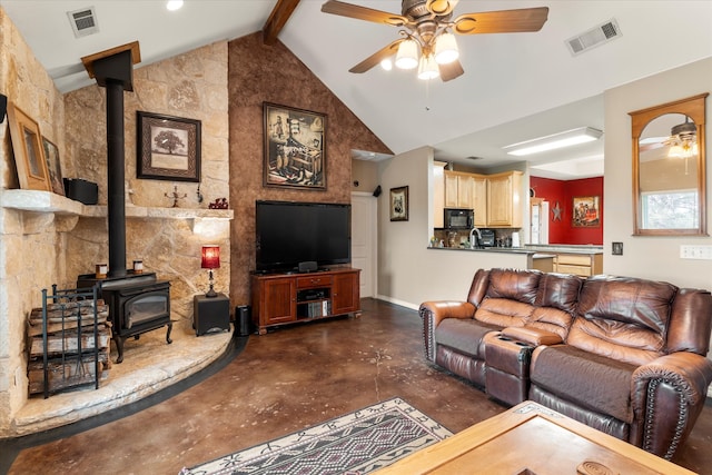 living room with high vaulted ceiling, ceiling fan, a wood stove, and beamed ceiling