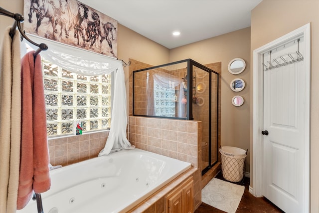 bathroom featuring separate shower and tub