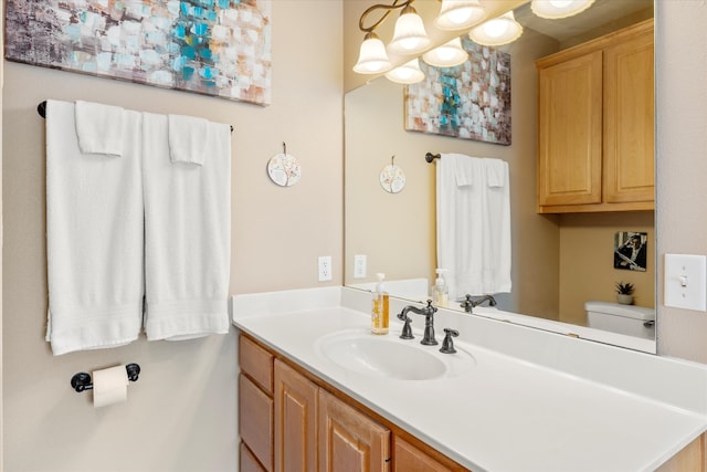 bathroom featuring toilet and vanity