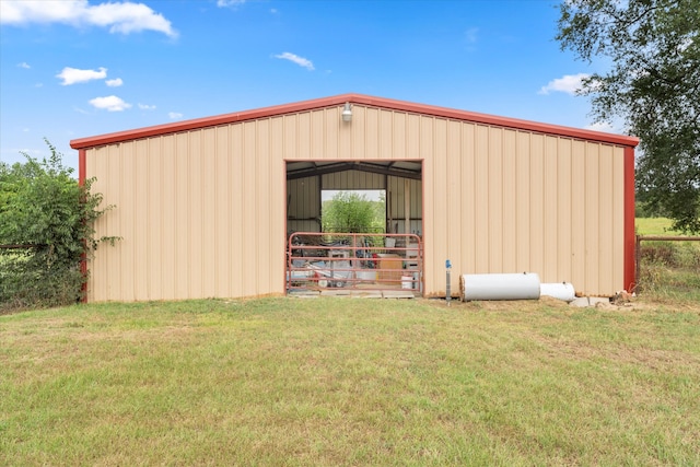 view of outbuilding with a yard