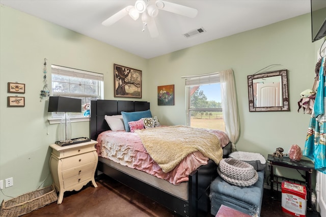 bedroom with ceiling fan and multiple windows