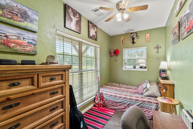 bedroom featuring ceiling fan and carpet