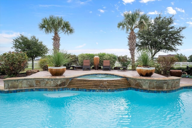 pool featuring a patio area and an in ground hot tub