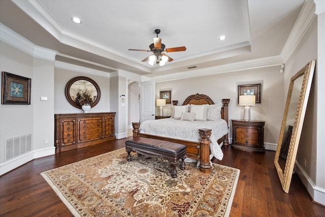 bedroom featuring crown molding, ceiling fan, a raised ceiling, and dark hardwood / wood-style flooring